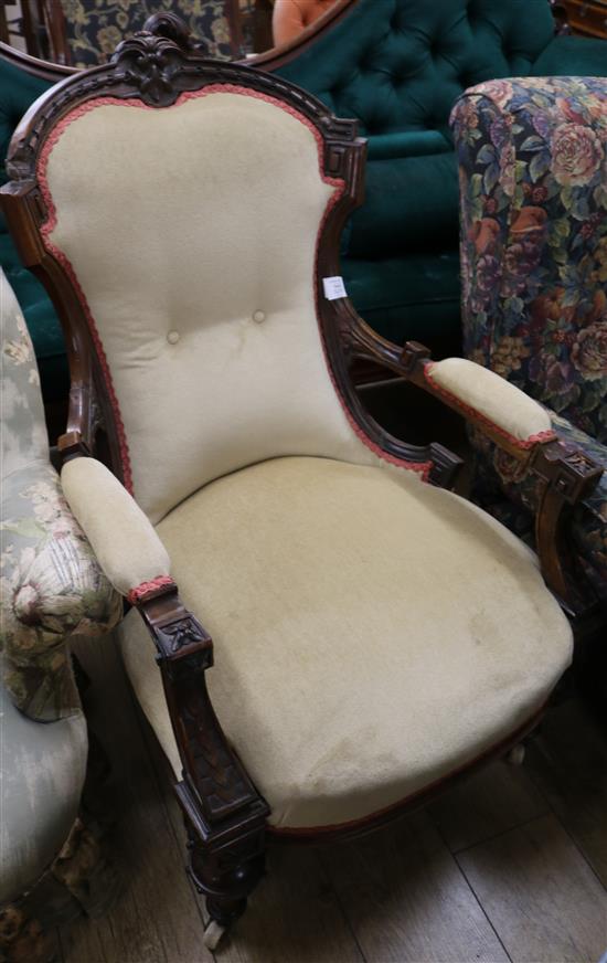 A Victorian carved walnut armchair, with shaped back on turned fluted legs